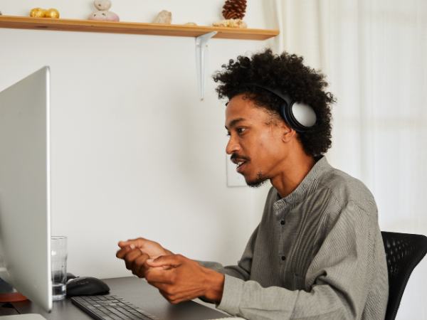 A man is at home talking to his therapist during virtual addiction rehab