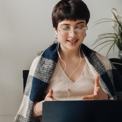 A young woman talking to her therapist through a video call