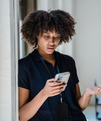 A woman uses her mobile phone for a web-based video call for mental health therapy