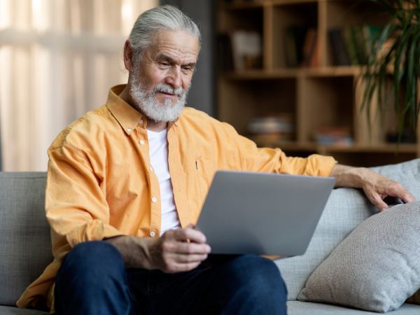 A senior man using his tablet for drug and alcohol virtual rehab