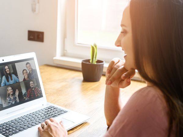 A woman at home using her laptop for a group psychotherapy session