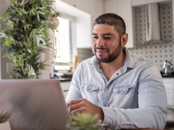 A man sitting in the kitchen at home during a remote therapy session