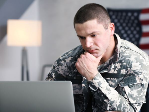 A soldier listens to his therapist during an online mental health session