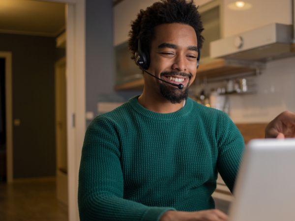 A man sitting in the kitchen during an online rehab therapy session