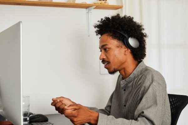 A man is at home talking to his therapist during virtual addiction rehab